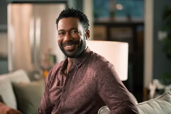 Dion Johnstone as Erik, smiling