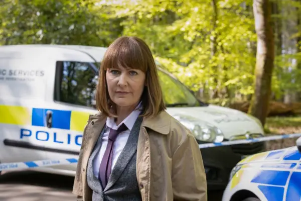 Michelle Jeram stars in Granite Harbour standing in front of police vehicles