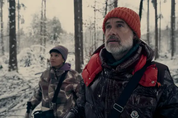 Murray Bartlett as Brian in NPS, stood in a forest with snow in the background