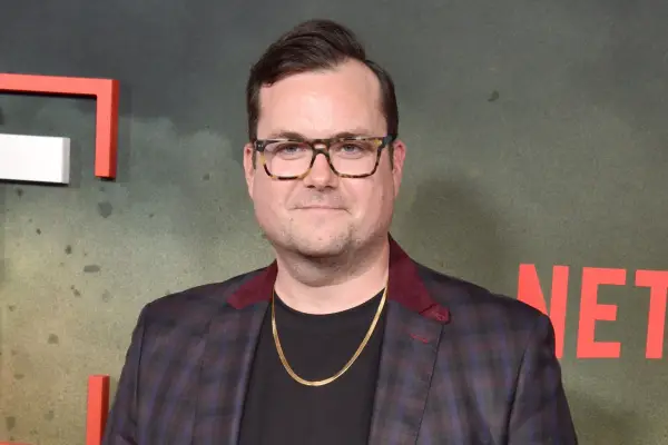 Kristian Bruun in a black T-shirt and plaid suit