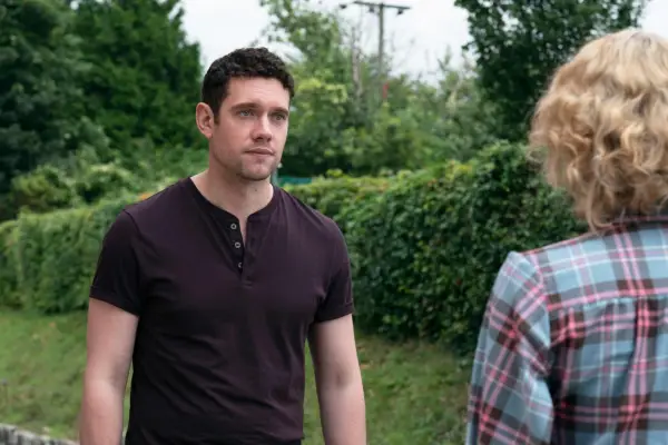 Will wearing a burgundy t-shirt, looking at Bonnie