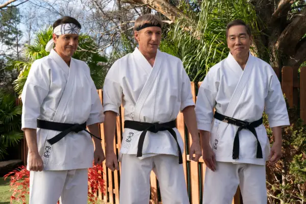 Daniel, Johnny and Chozen in white karate gi in the garden of Daniel