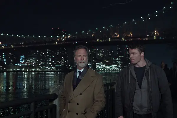 Louis Herthum as Jacob Monroe and Gabriel Basso as Peter Sutherland in The Night Agent, walking along the waterside