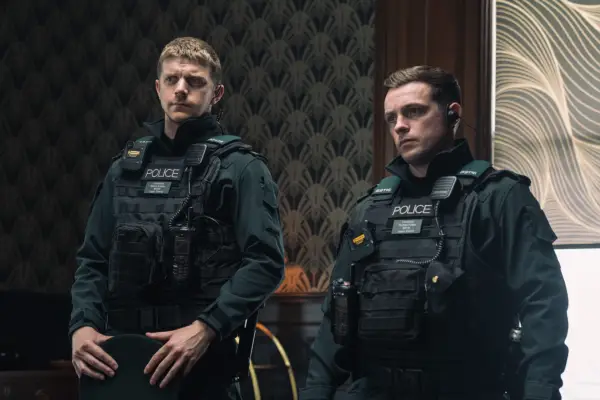 Frank Blake as Shane Bradley and Nathan Braniff as Tommy Foster in Blue Lights. They are both wearing uniforms and looking at someone off screen.