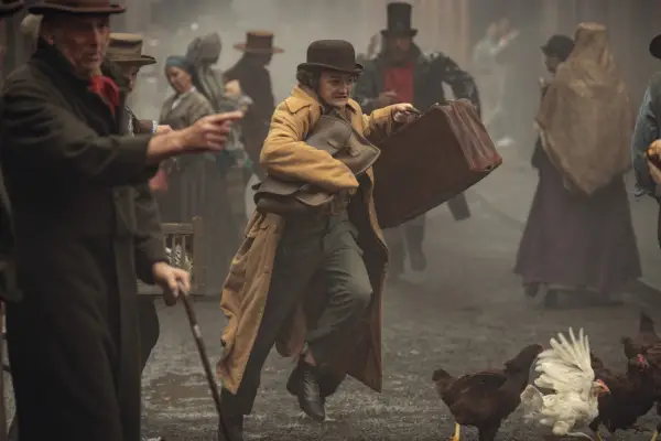 Jack Gleeson stars in House of Guinness; his character is seen here navigating a busy 1800s street, avoiding people and loose chickens as he rushes around