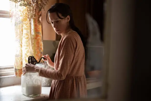 Chloe Pirrie as Matilda Lafferty, stood at a countertop and looking down in Under the Banner of Heaven