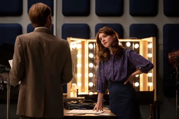 Daisy Edgar-Jones as Brenda Lafferty, stood by a mirror and talking to a man in Under the Banner of Heaven