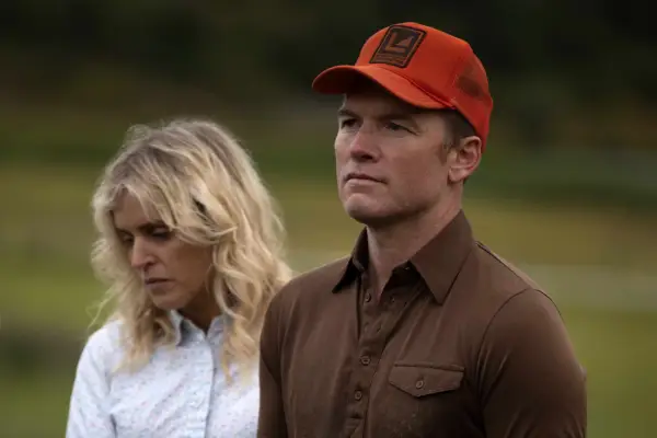 Denise Gough as Dianna Lafferty and Sam Worthington as Ron Lafferty, stood next to each other in Under the Banner of Heaven