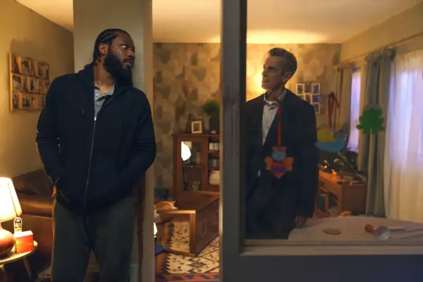 Tom Moutchi and Peter Capaldi stood in a flat and looking at one another in Criminal Record