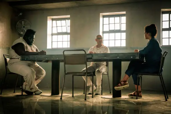 Atkins Estimond as Dillon Kempton (left) with Stanley Tucci as Jefferson Grieff and Lydia West as Beth Davenport in Inside Man.