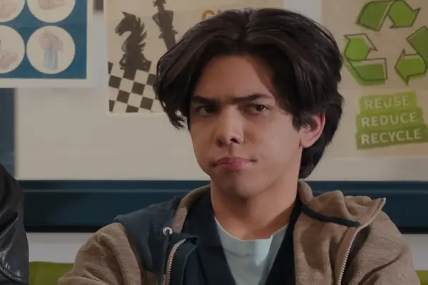 Myles Vincent Perez as Lee Garcia looking unimpressed as someone is talking to him.