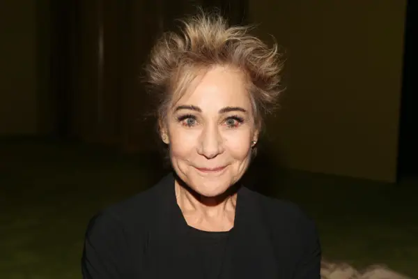 Zoë Wanamaker wearing a brown outfit, looking into camera