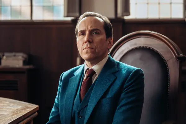 Ben Miller as Professor T, wearing a blue suit