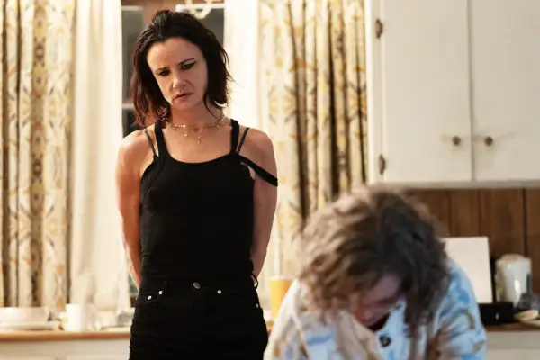 Adult Nat watching Misty from afar with a perturbed expression on her face