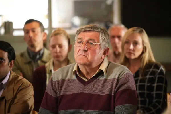 Ifan Huw Dafydd as Noel Thomas, sat down with other people