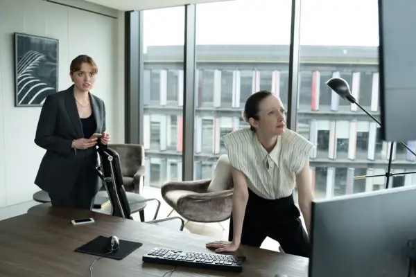 Aimee Lou Wood and Andrea Riseborough, looking at a computer in an office in Alice & Jack