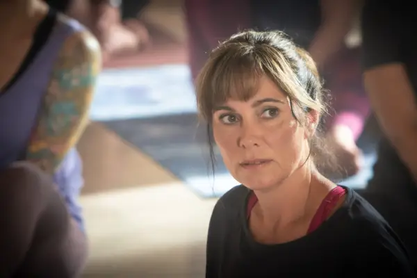 Fiona Dolman plays Sarah Barnaby sitting in a black shirt