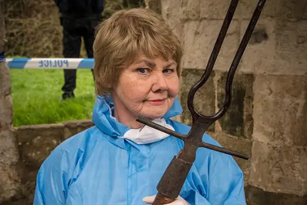 Annette Badland plays Fleur Perkins in Midsomer Murders, wearing a blue hazmat suit