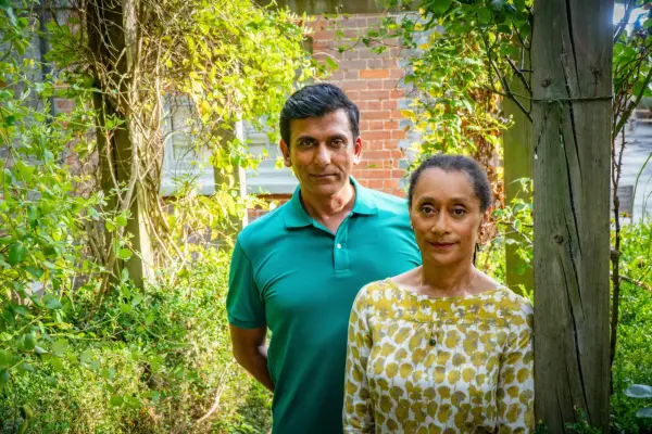 Ace Bhatti as Dickie Dent and Suzanne Packer as Olivia Dent in Midsomer Murders, looking at the camera