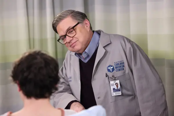 Oliver Platt as Daniel Charles, wearing his uniform and talking to a patient
