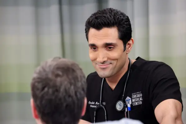 Dominic Rains as Crockett Marcel wearing his uniform, talking to a patient