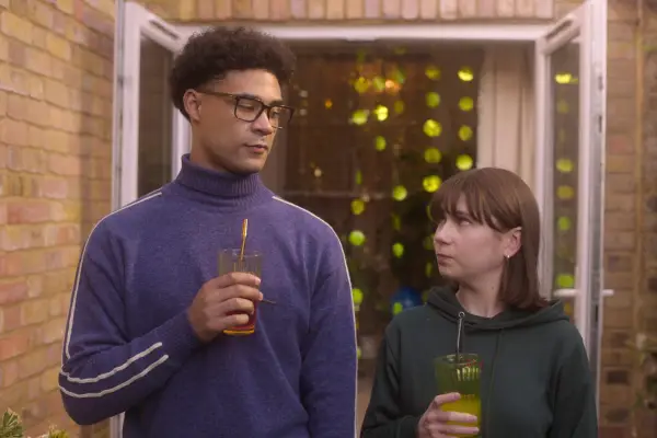 Michael and Tori stand next to each other holding drinks