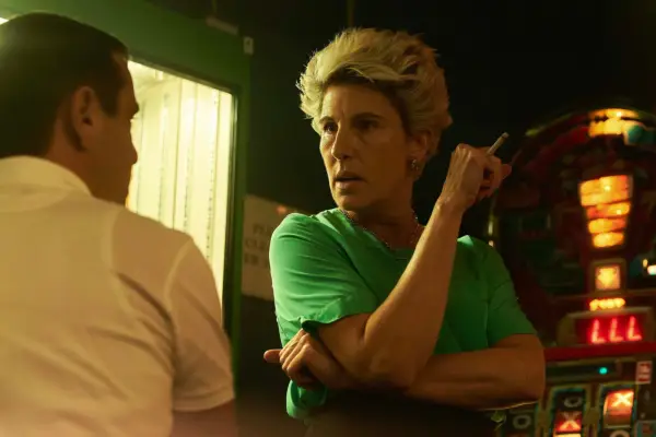 Cecilia Logan looks aggressively towards younger brother Don, stood beside her, while smoking a cigarette