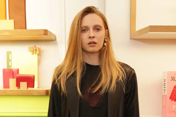 Clea Martin attends an event, wearing a burgundy top and black jacket