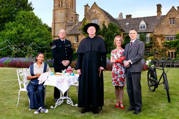 Ruby-May Martinwood as Brenda Palmer, John Burton as Sgt Goodfellow, Mark Williams as Father Brown, Claudie Blakley as Mrs Devine and Tom Chambers as Chief Inspector Sullivan in Father Brown, stood outside in front of the church