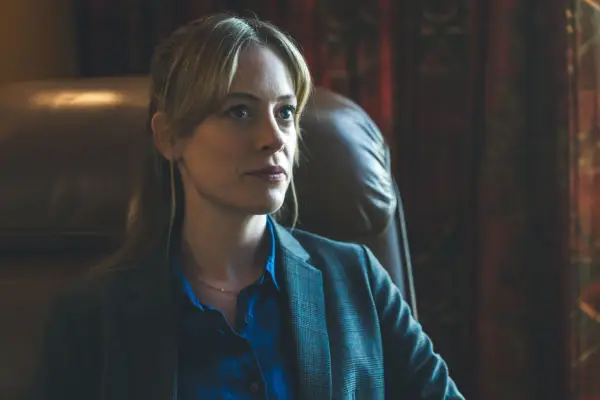 Hannah McClean as Jen Robinson in Blue Lights, sat in an armchair