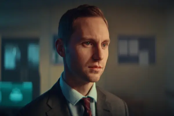 Desmond Eastwood as Murray Canning in Blue Lights, wearing a suit and looking offscreen