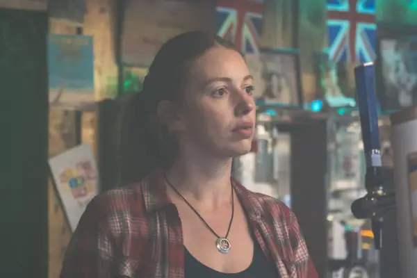 Seana Kerslake in Blue Lights stood behind a bar