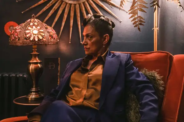 Cathy Tyson sitting in a darkened room