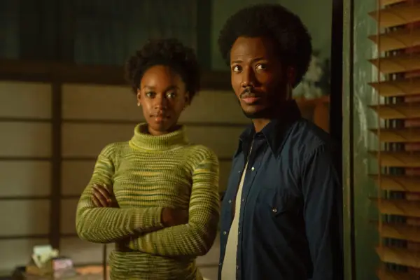 Lou and Miles stood looking directly at the camera