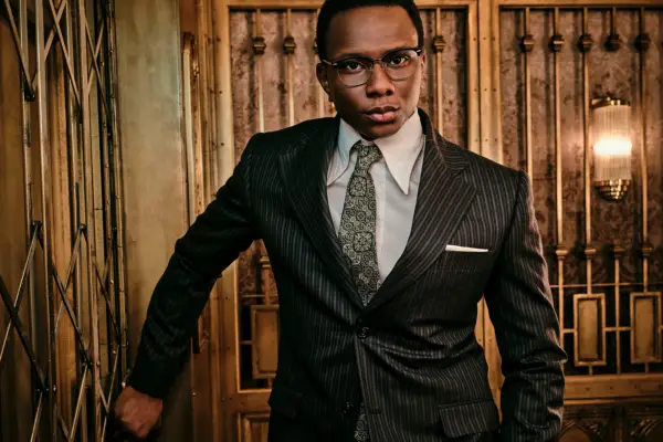 Charon wearing a suit, stood inside The Continental