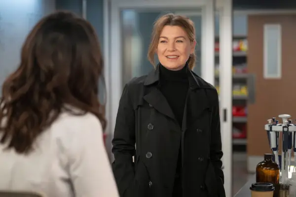 Ellen Pompeo dressed in a black jumper and black coat as Dr Meredith Grey in Grey