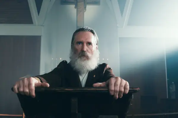 Chanel Cresswell as Tammy Horniman, sat on a chair, with a magazine in her hands