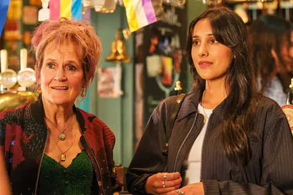 Lorraine Ashbourne as Jess and Taj Atwal as Nisha Lal, standing next to one another in a pub