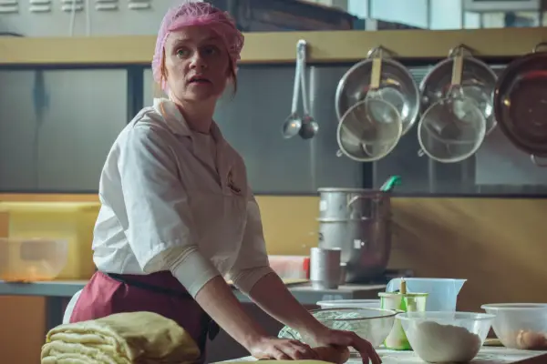 Natalie Gavin as Joanne Wells wearing a uniform and hair net while making bread in Passenger.