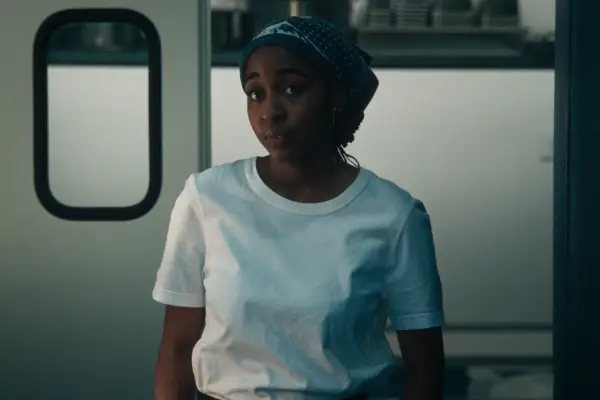 Ayo Edebiri as Sydney in The Bear stood in a kitchen