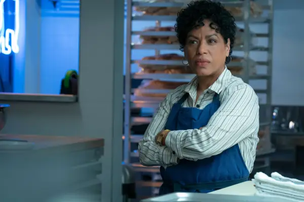 Liza Colón-Zayas as Tina in The Bear, with her arms crossed