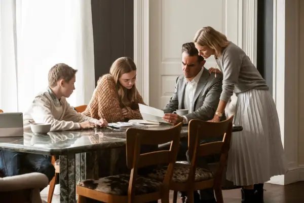 the Brannock family sat around the dining table reading a letter