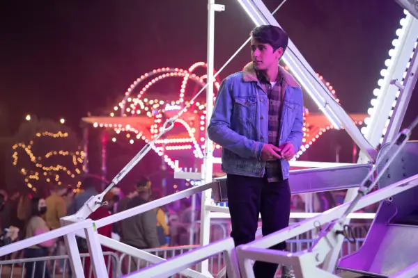 Victor stands by a ferris wheel in the finale of Love Victor