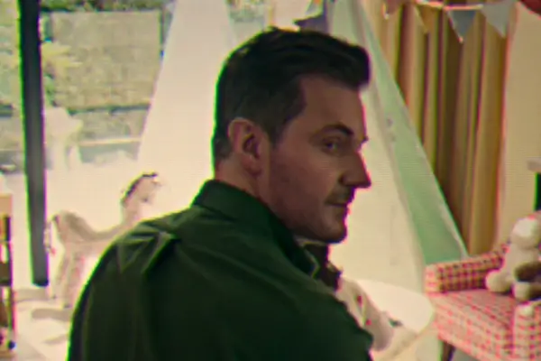 Richard Armitage as Joe in Fool Me Once looking behind himself as captured in the nanny cam.