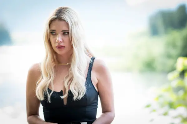 Ashley Benson as Cara in Wilderness wearing a black dress
