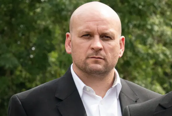 Ricky Champ as Stuart Highway in a suit without a tie for EastEnders.