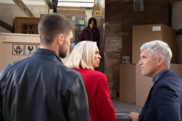 Ruby looking at Caleb as Joe looks on and Anya watches from a van in Emmerdale