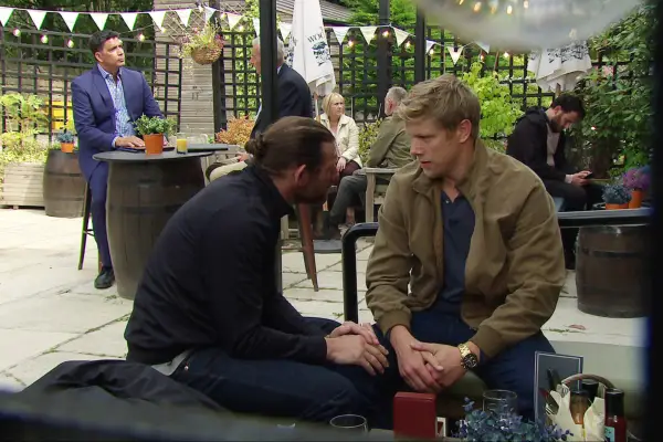 Kev and Robert sitting outside and talking in Emmerdale