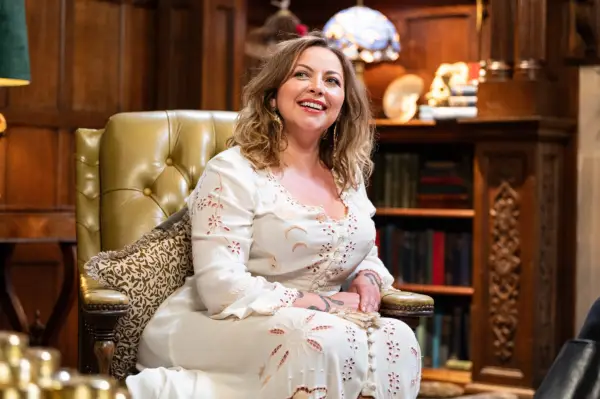 Charlotte Church wearing a white dress, smiling as she looks upwards.
