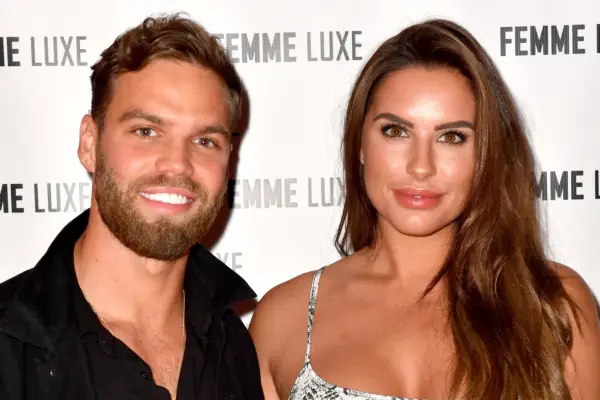 Jessica Shears and Dom Lever posing next to each other. They are smiling and are looking ahead.